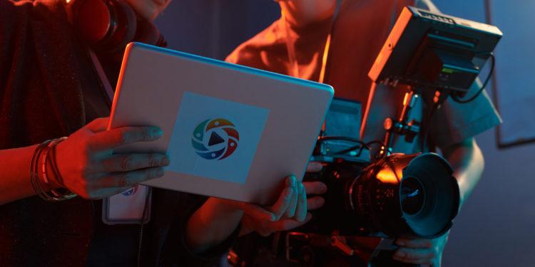 Cropped shot of video production crew discussing images on digital tablet screen copy space